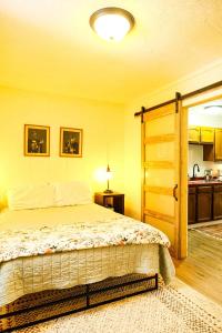 a bedroom with a bed and a open door at Snowbound Bliss at Powderhorn Mountain in Bessemer +11 photos