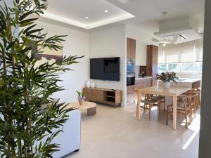 a kitchen and living room with a table and a tv at Apartamentos Las Mereras in Fuente Palmera