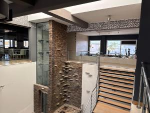 a staircase in a house with a brick wall at Apartamentos Las Mereras in Fuente Palmera