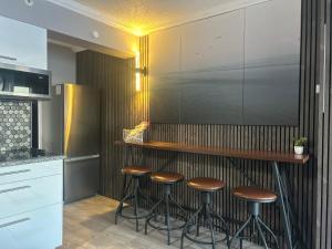 a kitchen with a bar with stools at Theo's Oceanfront Breeze in Myrtle Beach +8 photos
