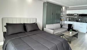 a bedroom with a large bed and a couch at Theo's Oceanfront Breeze in Myrtle Beach