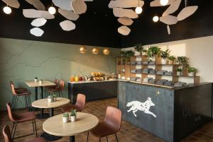 a restaurant with tables and chairs and a counter at The Outrider Hotel in Manitou Springs +47 photos