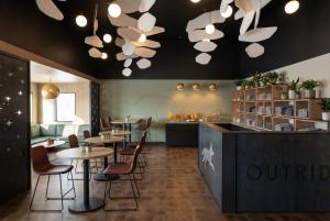 a restaurant with tables and chairs and a counter at The Outrider Hotel in Manitou Springs