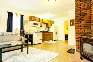 a living room with a couch and a kitchen at Elevated Ski Chalet at Powderhorn Mountain in Bessemer