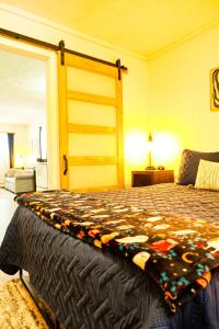 a bedroom with a bed with a blanket on it at Elevated Ski Chalet at Powderhorn Mountain in Bessemer