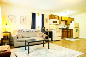 a living room with a couch and a kitchen at Elevated Ski Chalet at Powderhorn Mountain in Bessemer +21 photos