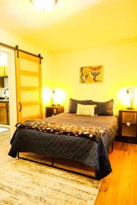 a bedroom with a bed with two night stands and two lamps at Elevated Ski Chalet at Powderhorn Mountain in Bessemer