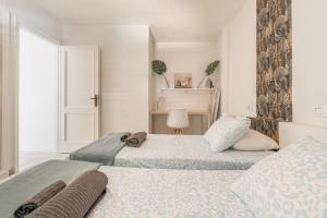 a bedroom with two beds and a window at The Energy Apartment in Caleta De Fuste