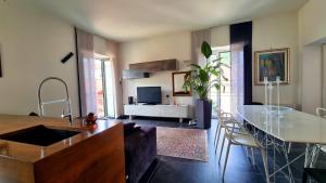 a living room with a table and a living room with a tv at Maison Grimoaldo10 in Salerno