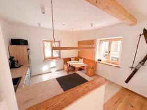 a kitchen with white walls and a table in a room at Alpenchalet Wasserfallblick in Ramsau
