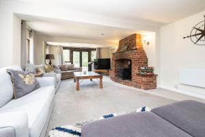 a living room with a couch and a fireplace at Gildridge in Lewes