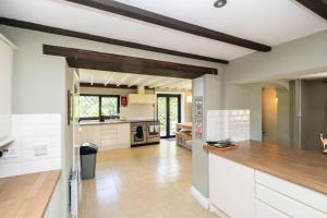 a kitchen with white cabinets and a wooden counter top at Gildridge in Lewes