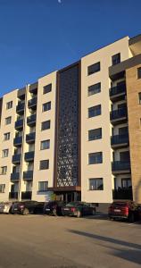 a large building with cars parked in front of it at Splendida in Bosanska Gradiška