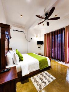 a bedroom with a bed and a ceiling fan at Ever Breeze Villa Ahangama in Ahangama