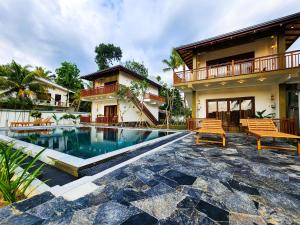 a house with a swimming pool in front of a house at Ever Breeze Villa Ahangama in Ahangama