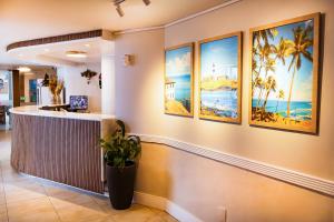 a lobby of a hotel with paintings on the wall at Bahia Sol e Mar in Salvador