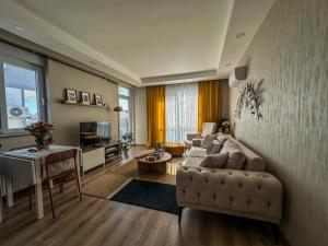 a living room with a couch and a table at Chic 2BR City Center Flat in Antalya