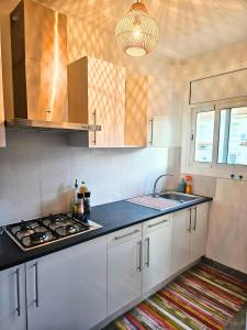 a kitchen with a sink and a stove top oven at Digital Nomad Apartment in L'Escala
