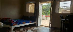a bedroom with a bed and a door to a porch at Lucky Homes in Srīvardhan