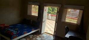 a bedroom with a bed in a room with two windows at Lucky Homes in Srīvardhan +30 photos