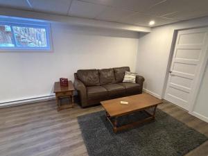a living room with a couch and a table at Gîte du Ruisseau in Lamarche