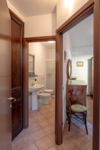 a bathroom with a toilet and a sink at Casa Riale 4 in Stresa +15 photos