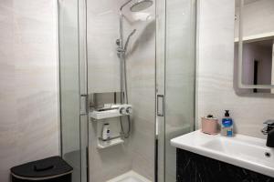 a bathroom with a shower and a sink at Family Airport in Chişinău