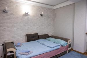 a bed with a person laying on it in a room at Family Airport in Chişinău +7 photos