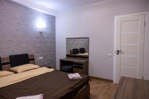 a bedroom with a bed and a mirror and a sink at Family Airport in Chişinău