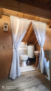 a bathroom with a white toilet in a attic at Il BORGO DEL VENTASSO in Busana