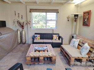 a living room with a couch and a table at The Urban Oasis 4 guests Port Elizabeth Gqeberha in Gqeberha