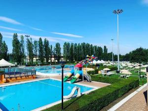 a large swimming pool with a water park at Residence Ki House in Parma
