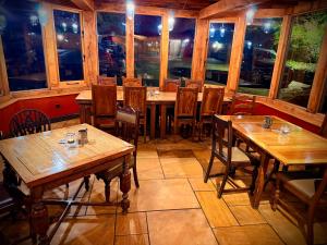 a restaurant with wooden tables and chairs and windows at Swan Hotel Forton in Forton +14 photos