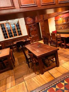 a dining room with wooden tables and chairs at Swan Hotel Forton in Forton