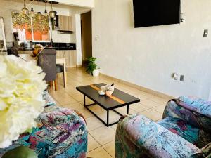 a living room with two couches and a coffee table at Casita Iluminada in Oaxaca City