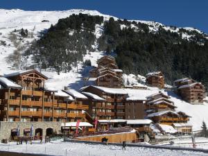 a large ski lodge with snow on a mountain at Scenic Apartment near Ski Area in Meribel in Méribel