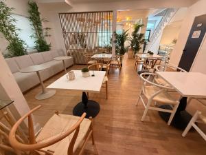 a restaurant with tables and chairs and a couch at Beachliner Hotel in Ocean Grove
