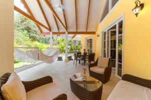 a living room with a couch and chairs and a table at Caribbean Hill Villas in Cocles
