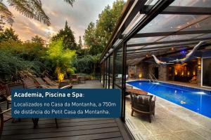 a villa with a swimming pool and a sign that reads argento positano at Petit Casa da Montanha in Gramado