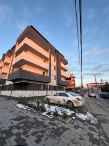 a car parked in a parking lot in front of a building at Garsoniera mobilata si utilata in Chiajna