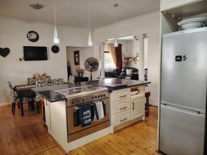 a kitchen with a stove and a refrigerator at The Urban Oasis 4 guests Port Elizabeth Gqeberha in Gqeberha