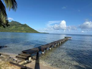 a dock in the middle of a body of water at Villa Vaihere in Orufara