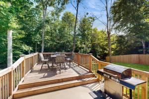 a wooden deck with a grill and a table and chairs at Gateway to Fort Campbell! Home w/ Furnished Deck in Clarksville