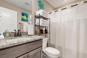 a bathroom with a toilet and a sink and a shower at Gateway to Fort Campbell! Home w/ Furnished Deck in Clarksville +17 photos