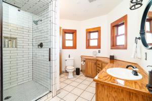 a bathroom with a shower and a sink and a toilet at Hot Tub + Dock! Waterfront Norris Lake Log Home in Elm Springs +32 photos