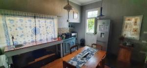a kitchen with a table and a sink and a dining room at Die Pophuis in Aberdeen
