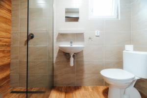 a bathroom with a toilet and a sink at Růžená - chatky u rybníka in Milevsko