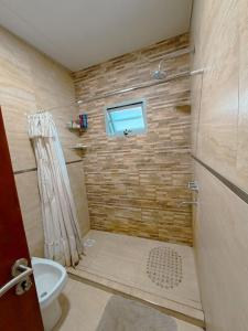 a bathroom with a shower and a toilet and a window at ParaisolaRinconada in La Porteña +23 photos