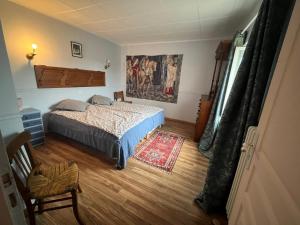 a bedroom with a bed and a rug at Lou Castel in Le Clapier