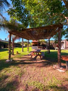 a picnic shelter with a picnic table in a park at ParaisolaRinconada in La Porteña